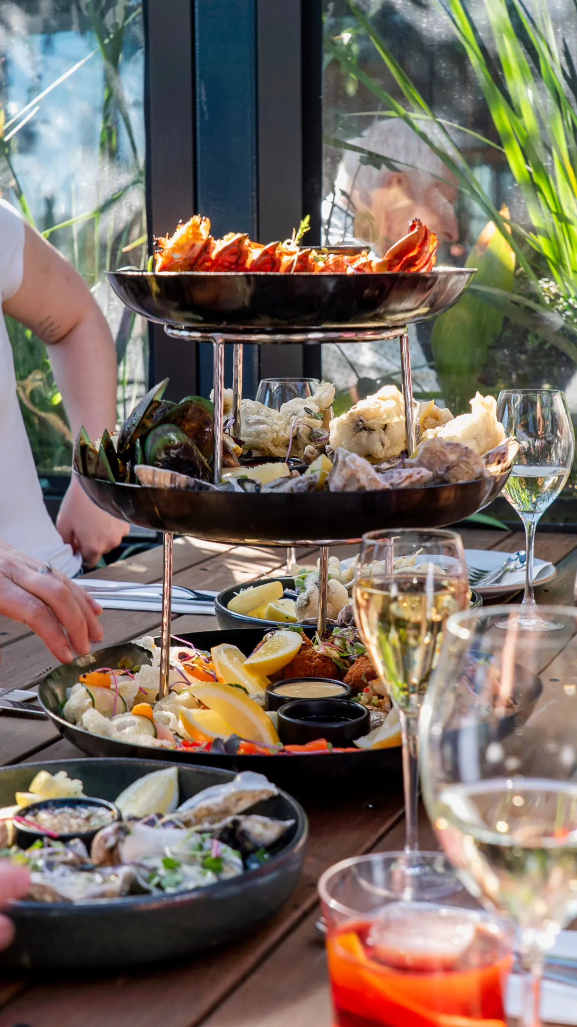 the seafood tower and a glass of wine